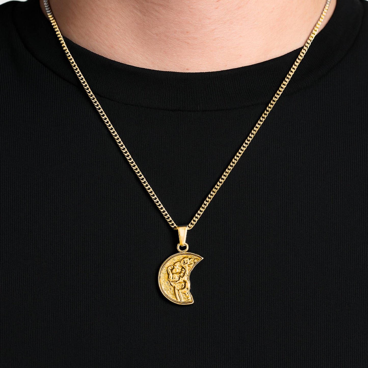 Gold necklace with a crescent moon pendant on a black background