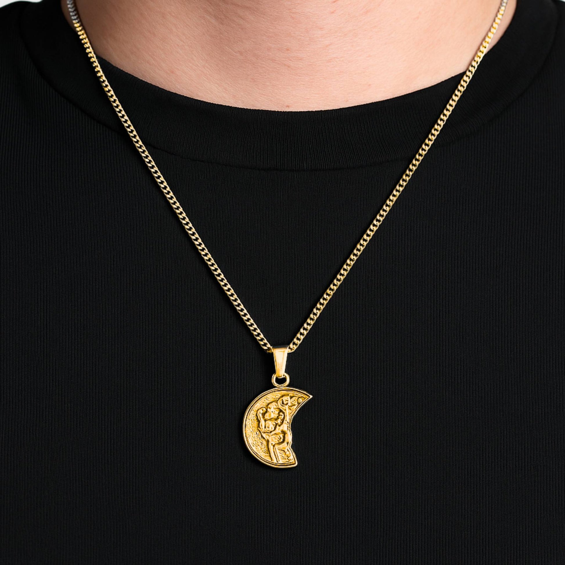 Gold necklace with a crescent moon pendant on a black background